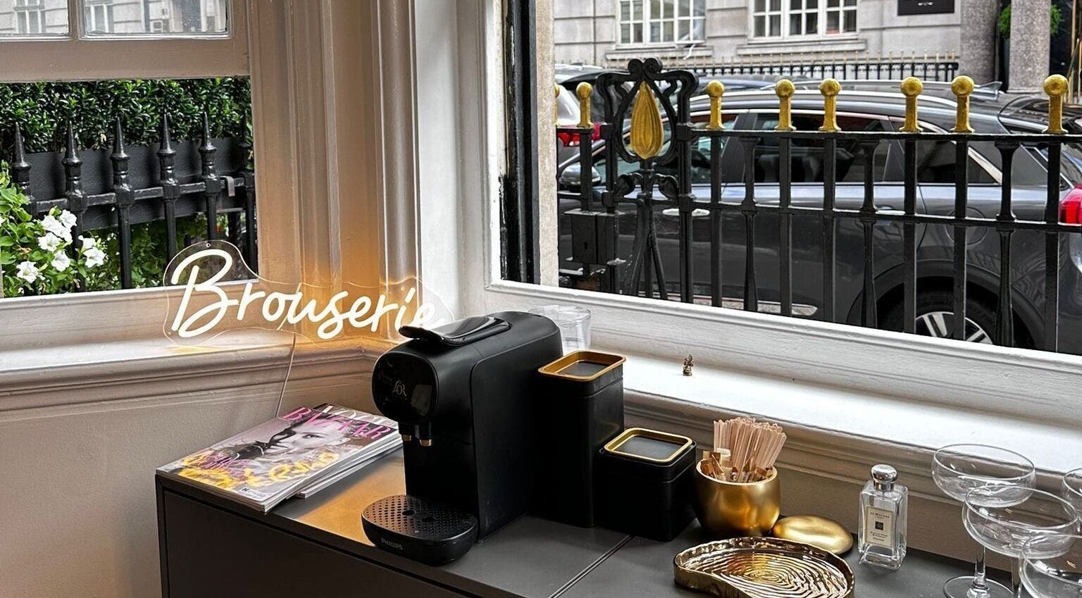 Elegant cafe setup at Browserie London, showcasing coffee amenities with street view in London, England, GB.