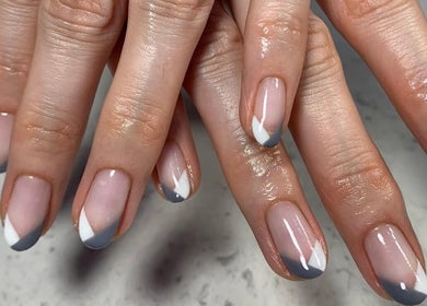 Elegant nail art with grey and white accents at Aspire Nail Care Studio, Greenwood Village, Colorado, US.