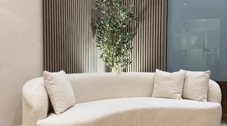 Elegant cream sofa with cushions at GLOWDEMIC in Old Town, Swindon, England, GB enhances relaxation.