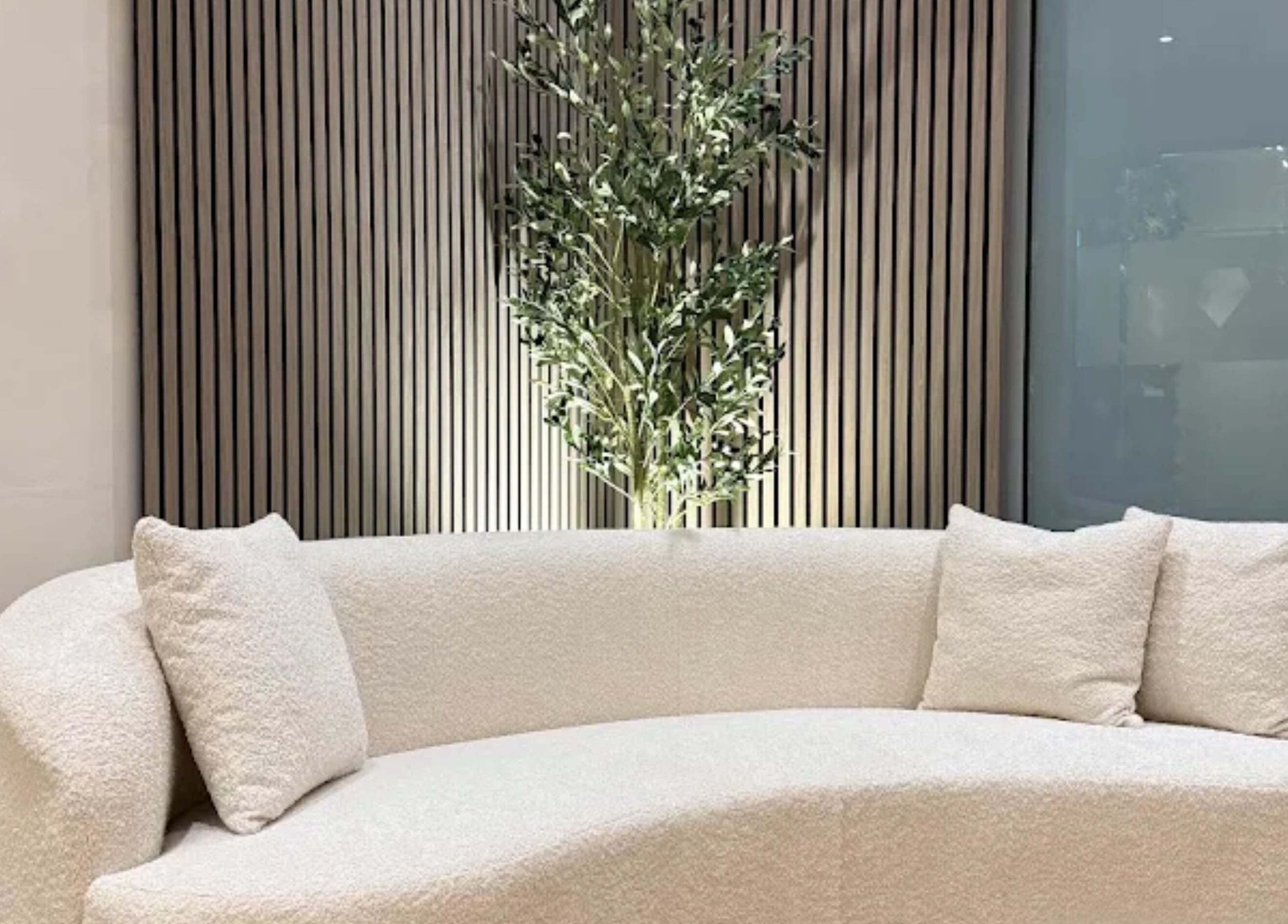Elegant cream couch at GLOWDEMIC, Old Town, Swindon, enhancing a sleek wellness space.