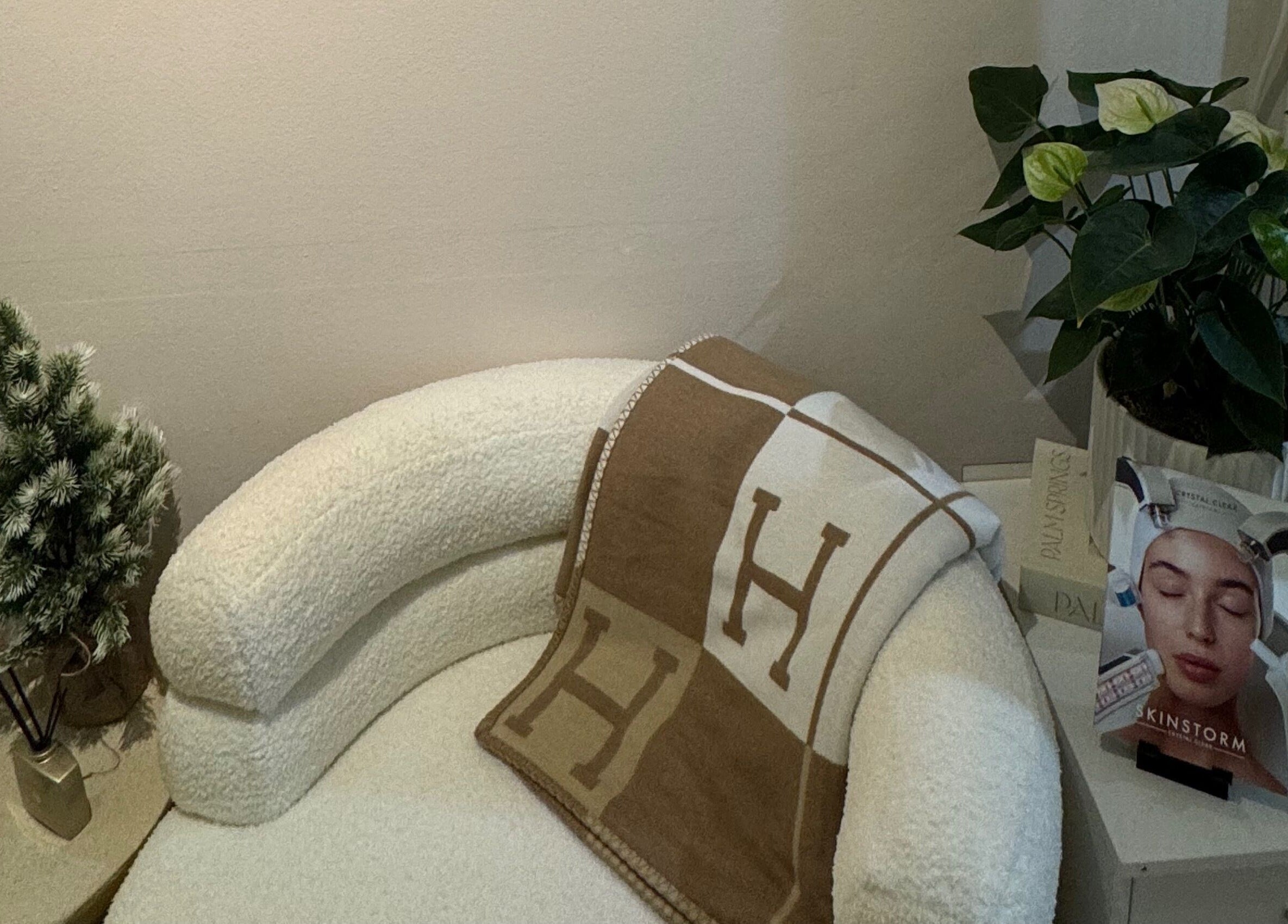 A cozy chair by plants and brochures at GLOWDEMIC, Old Town, Swindon, England, GB.