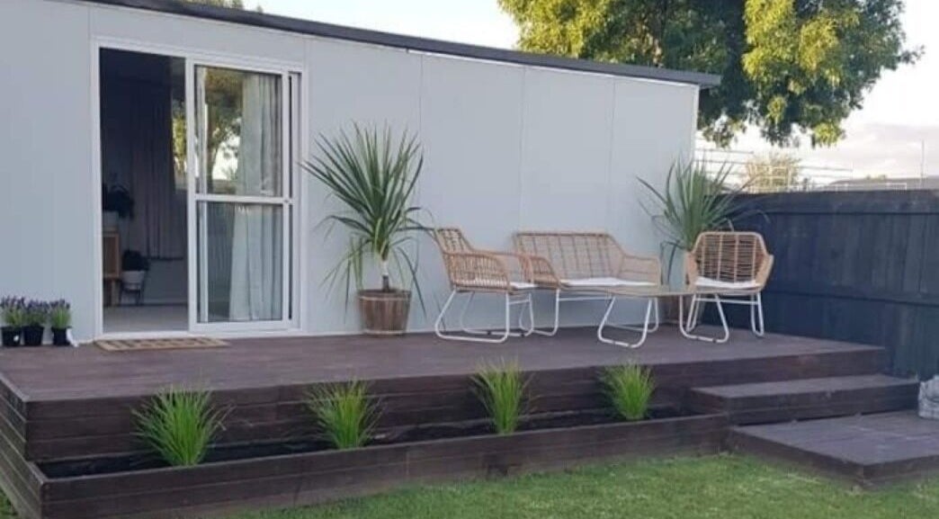 Outdoor seating area at My Little Oasis, Palmerston North, Manawatū-whanganui, NZ, featuring stylish wicker chairs.