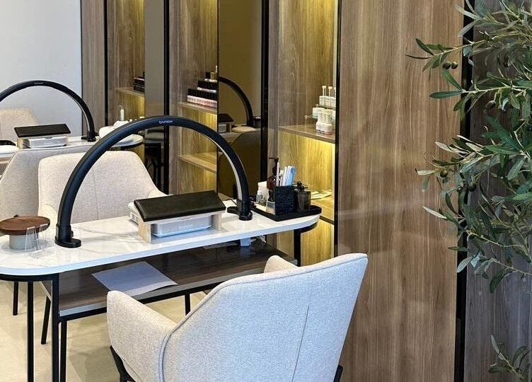 Elegant nail salon setup at So Spa, Riyadh, Riyadh Province, SA with modern chairs and lush decor.