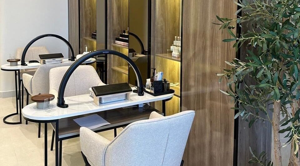 Elegant nail salon setup at So Spa, Riyadh, Riyadh Province, SA with modern chairs and lush decor.