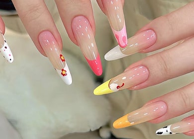 Colorful nail designs at Niko Nail Studio in La Verne, California, US, featuring floral and abstract patterns.