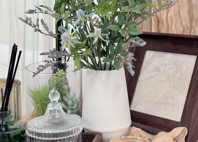 Chic decor at Niko Nail Studio in La Verne, California, US featuring vibrant florals and elegant glassware.