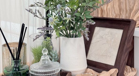 Chic decor at Niko Nail Studio in La Verne, California, US featuring vibrant florals and elegant glassware.