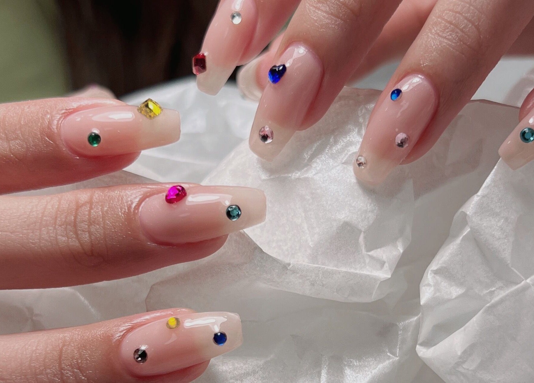 Elegant gem-accented nails at Niko Nail Studio, La Verne, California, US, showcasing artistry and style.