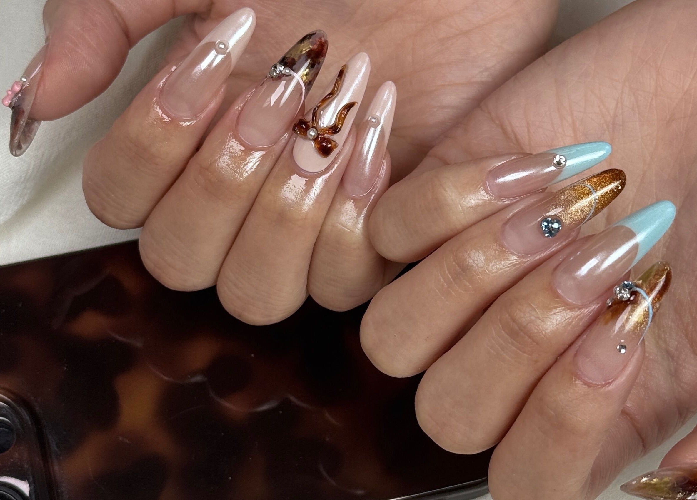 Detailed artistic nail designs at Niko Nail Studio, La Verne, California, US.