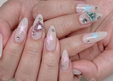 Elegant starry nail art with gemstones at Niko Nail Studio, La Verne, California, US.