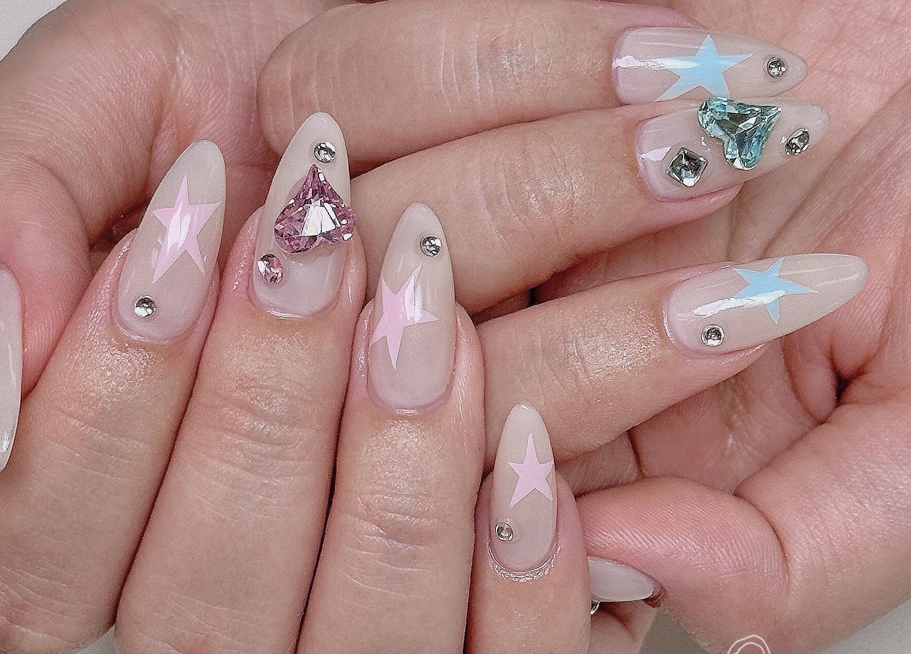Elegant starry nail art with gemstones at Niko Nail Studio, La Verne, California, US.