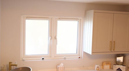 Bright, modern bathroom sink at Revitalizetherapies, Carlton Colville, England, GB, under a sunny window.