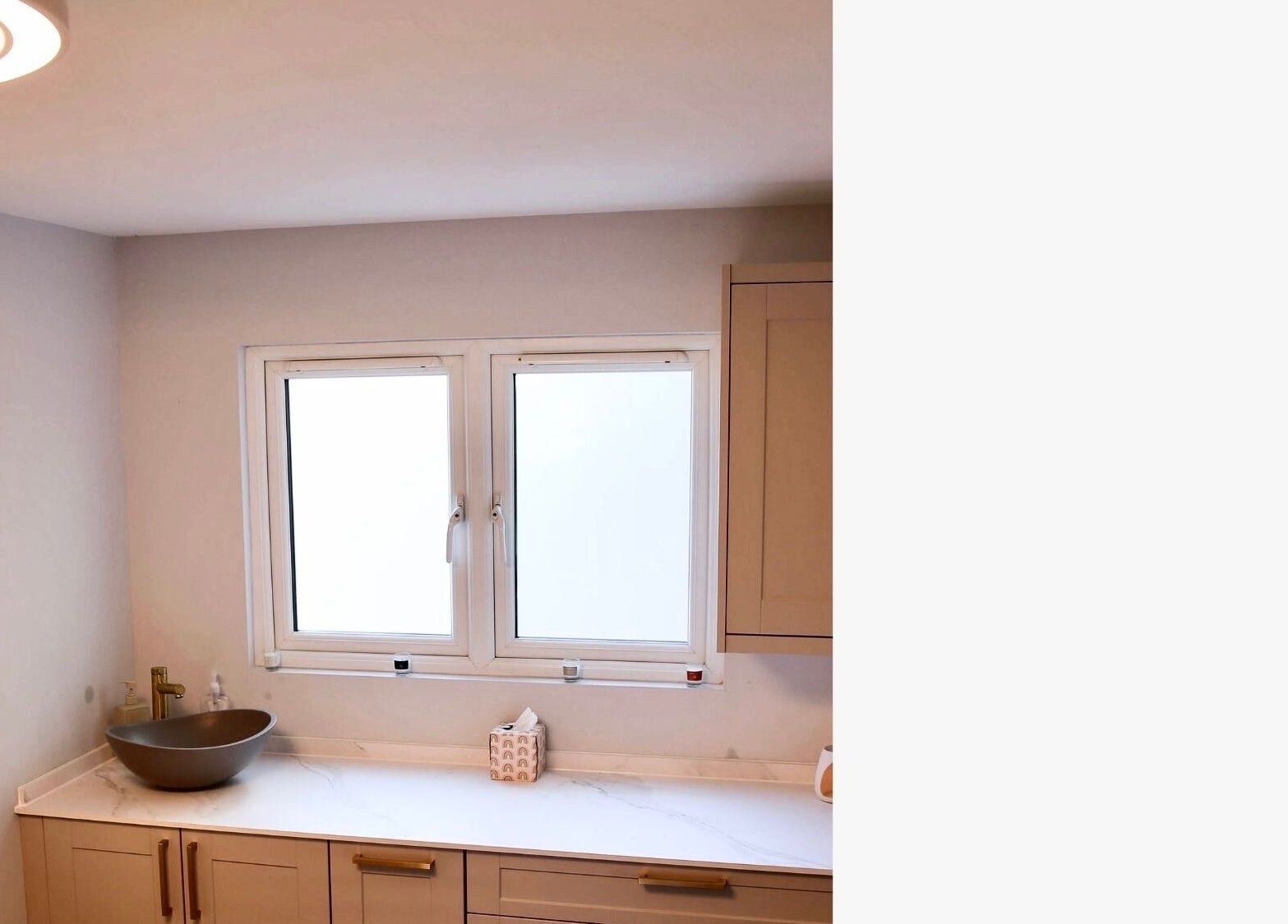 Elegant treatment room at Revitalizetherapies, Carlton Colville, England, GB featuring a modern sink and ample natural light.