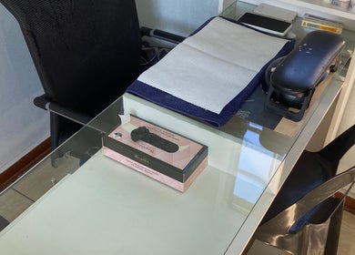 Manicure station at Glow District, Soweto, Gauteng, ZA, featuring tools on a sleek glass table.