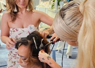 Hair stylist perfecting a style at Studio Queen Hair, Sherman Oaks, California, US.