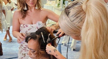 Hair stylist perfecting a style at Studio Queen Hair, Sherman Oaks, California, US.