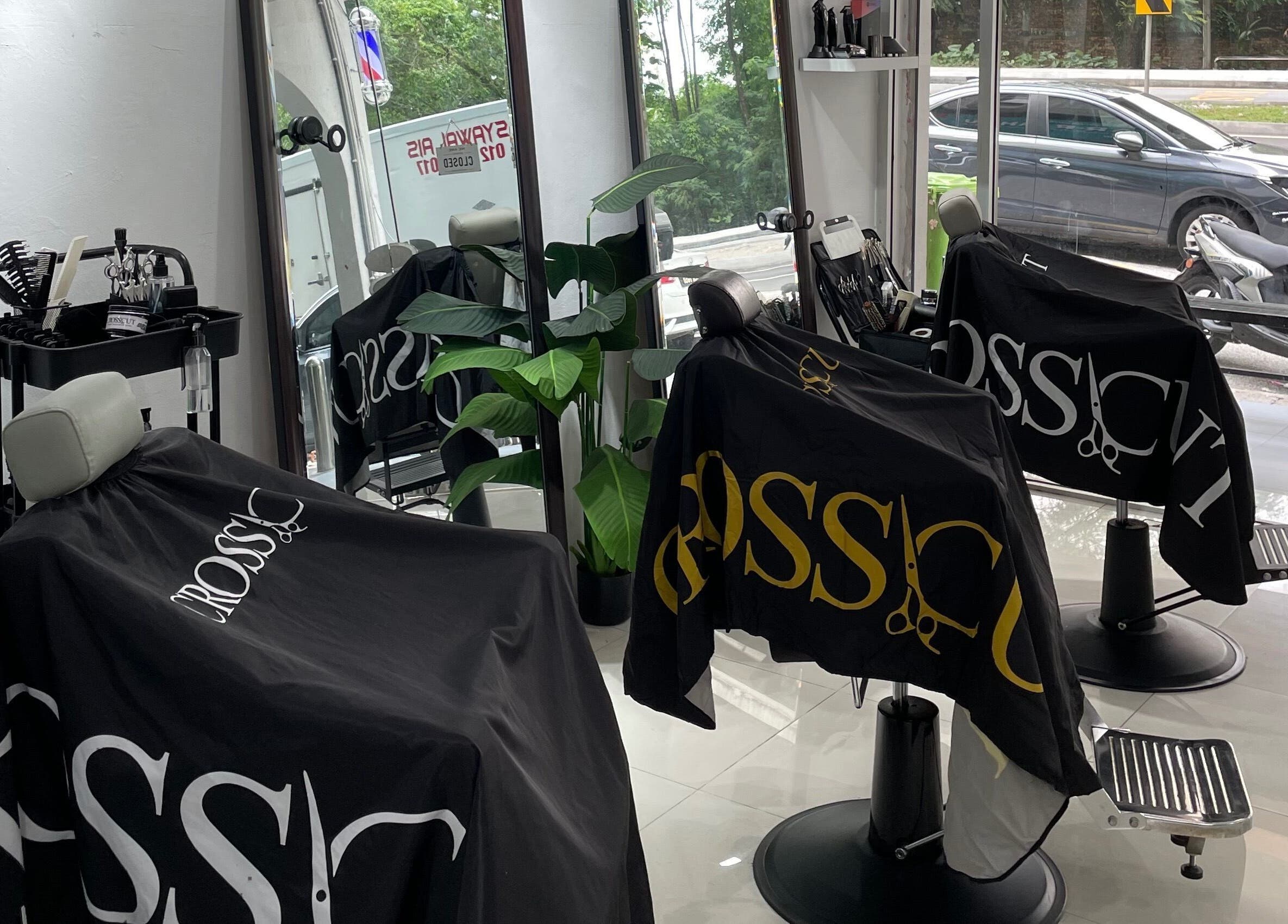 CROSSCUT BARBERS interior in Kuala Lumpur featuring sleek chairs and mirrors.