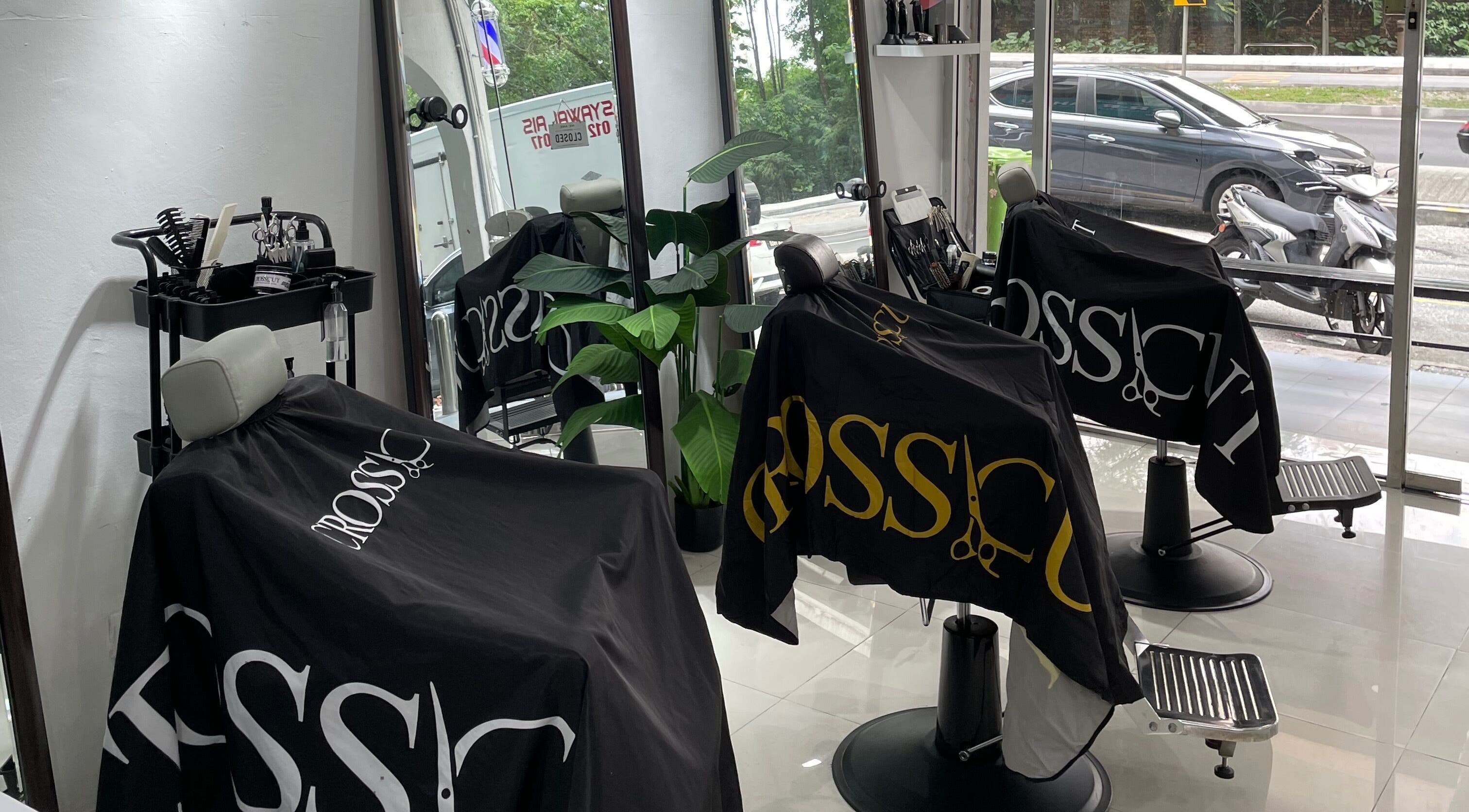 CROSSCUT BARBERS interior in Kuala Lumpur featuring sleek chairs and mirrors.