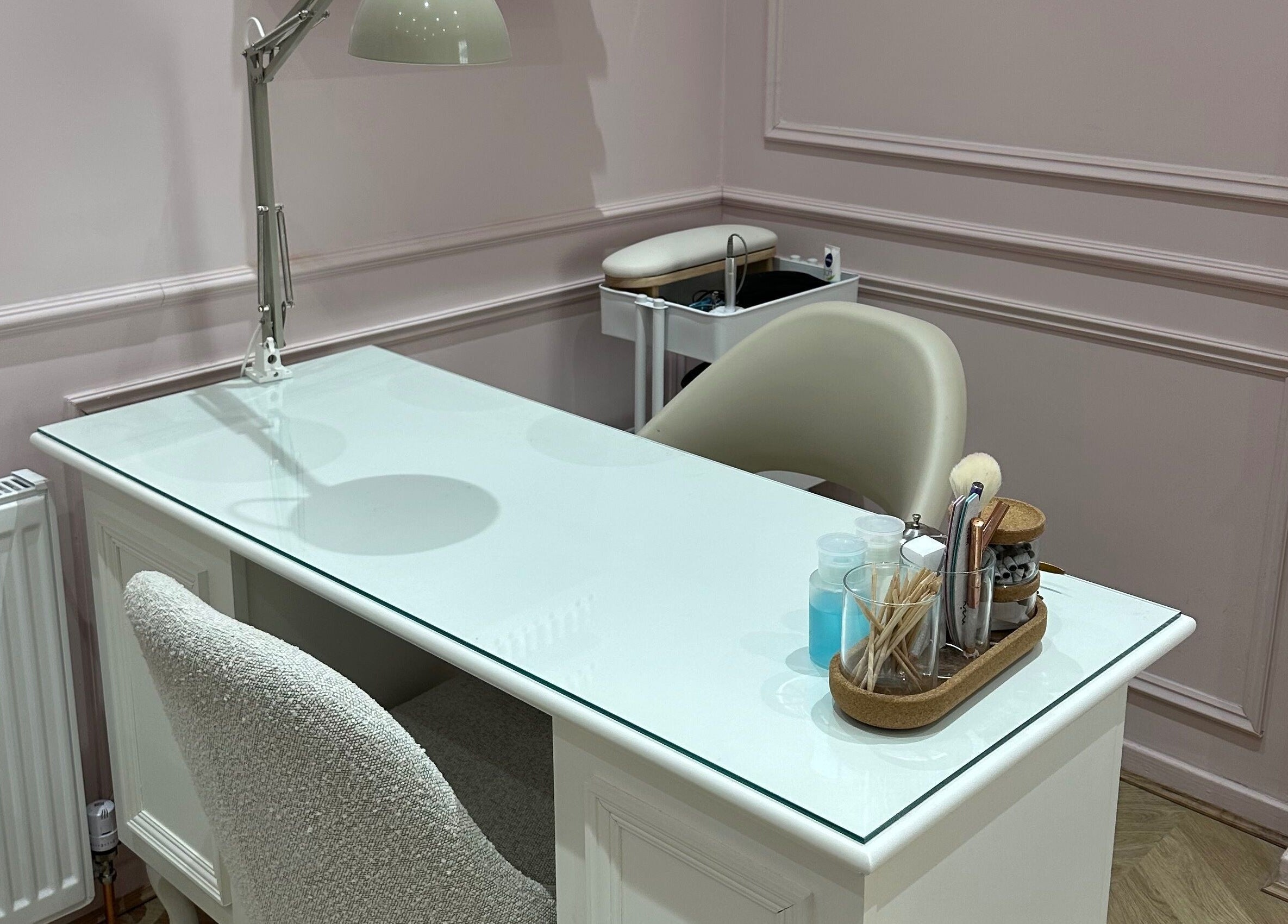 Stylish nail station at Nailsbyklc, Monton, England, GB, featuring a sleek white table and comfortable chair.
