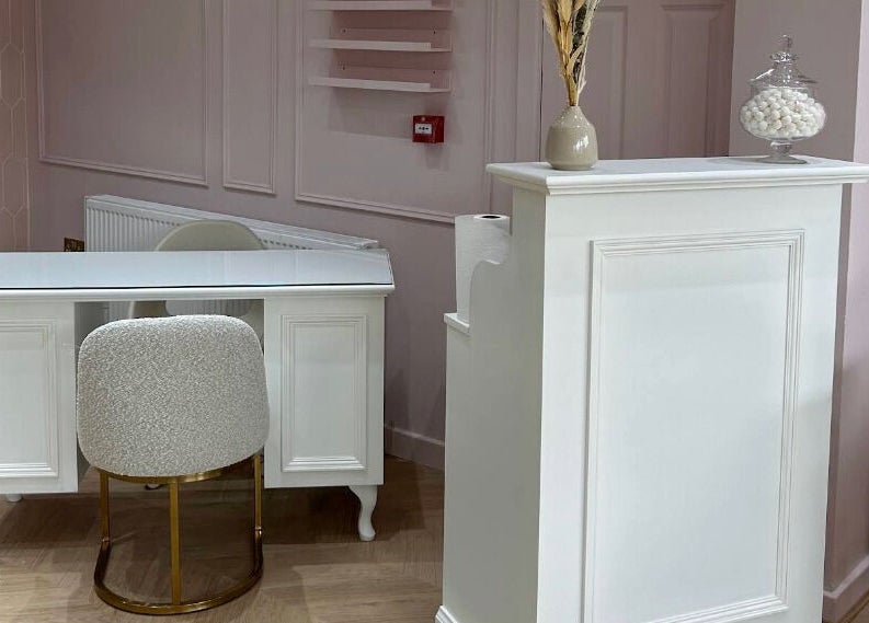 Stylish nail station at Nailsbyklc, Monton, England—modern, elegant design with soft pink walls.