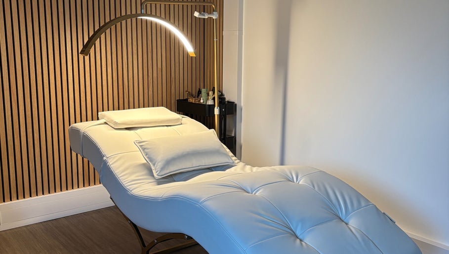 Luxurious treatment room at Defined by Amy Jane in Altrincham, England, GB featuring a plush white lounge chair.