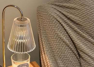 Elegant lamp and textured blanket at JC Japanese Eyelash in London, England, GB, creating a cozy ambiance.