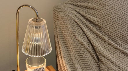 Elegant lamp and textured blanket at JC Japanese Eyelash in London, England, GB, creating a cozy ambiance.