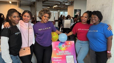 Friendly team at Pick A Color Studio, New York, New York, US welcoming visitors with smiles and colorful sign.