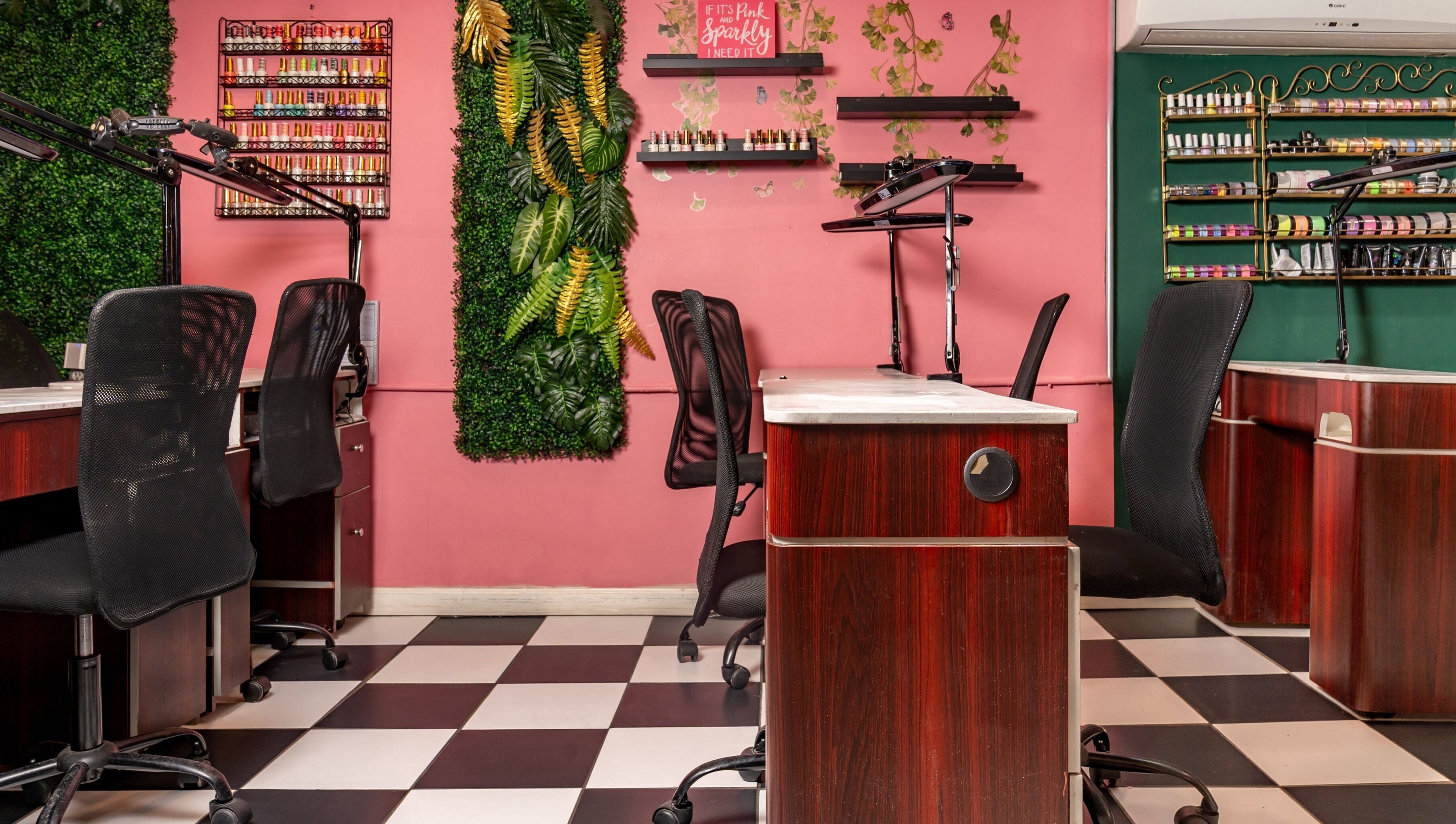 Stylish nail stations at Pick A Color Studio in New York, New York, US, with vibrant decor and greenery.