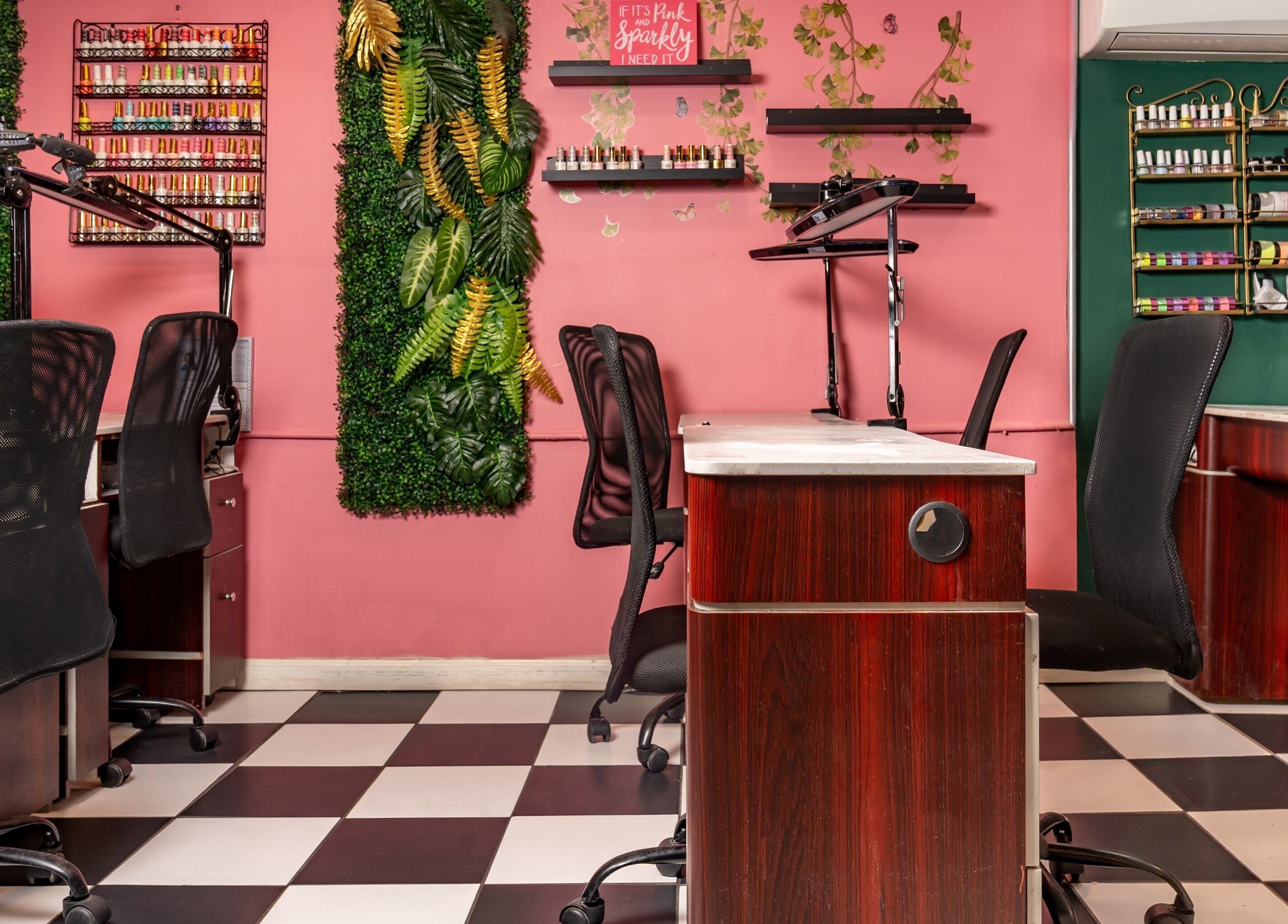 Stylish nail stations at Pick A Color Studio in New York, New York, US, with vibrant decor and greenery.