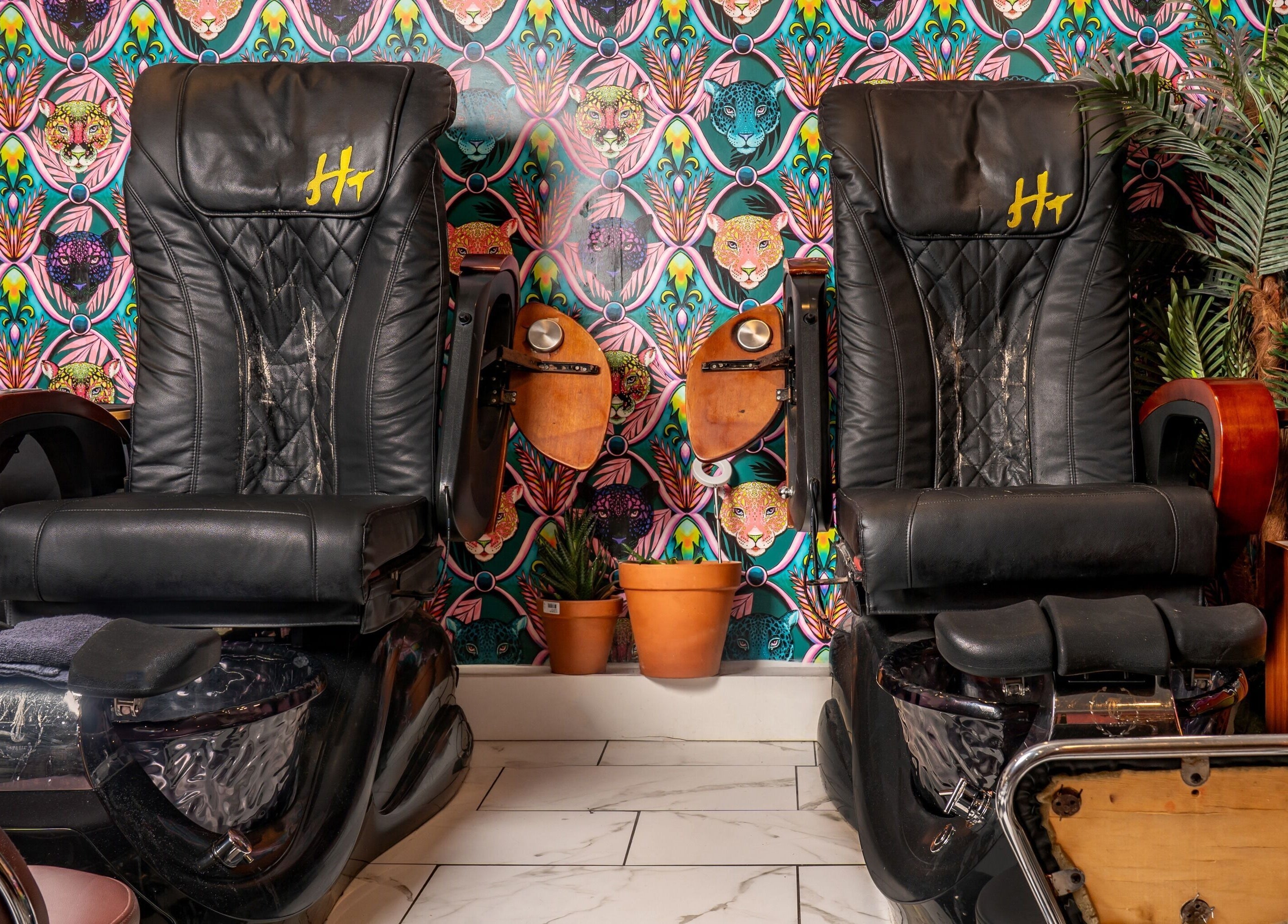Luxurious pedicure chairs at Pick A Color Studio, New York, New York, US with vibrant wallpaper backdrop.
