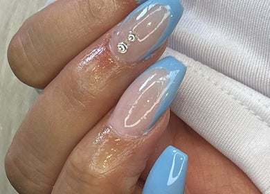 Elegant blue manicure at Lady Nails, Taupō, Waikato, NZ, showcasing detailed artistry and glossy finish.