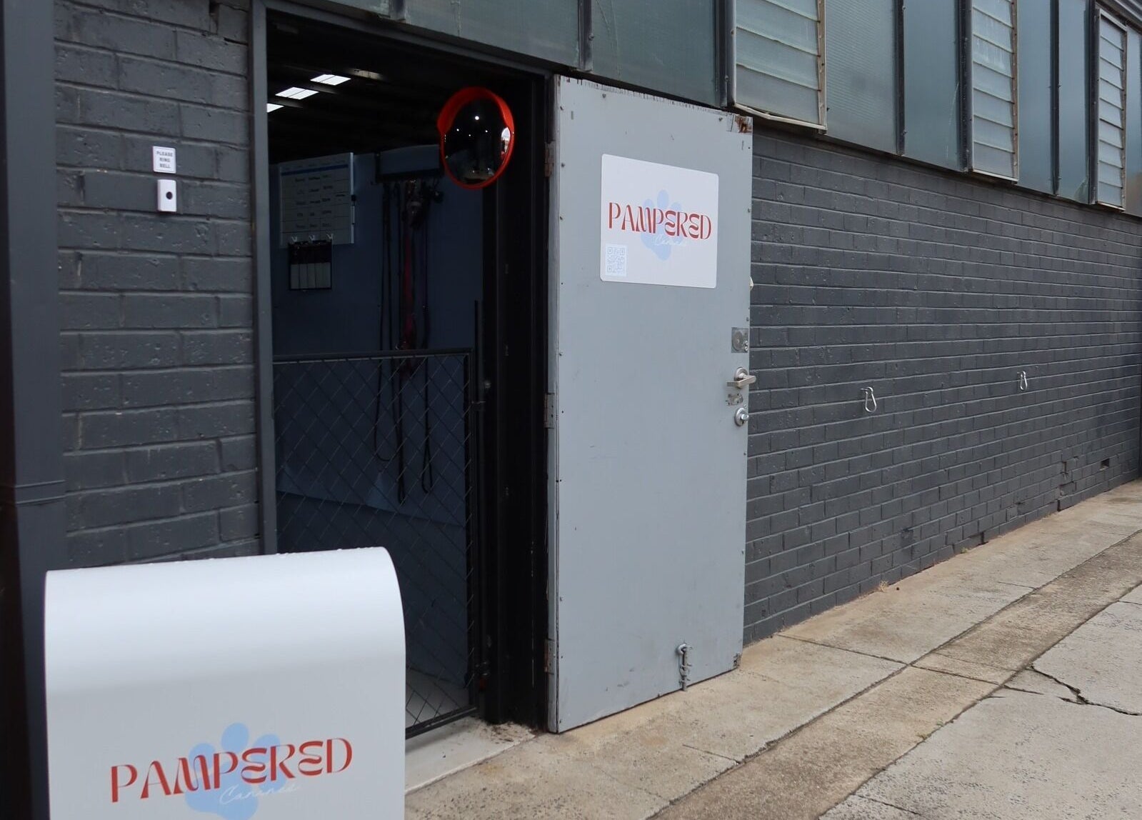 Entrance to Pampered Canines at Melbourne, Victoria, AU, showing an open door and modern facilities.