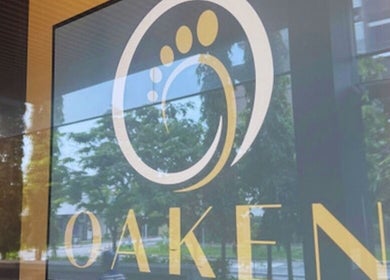 Oaken venue glass entry sign at Singapore, Singapore, SG amidst a serene backdrop.