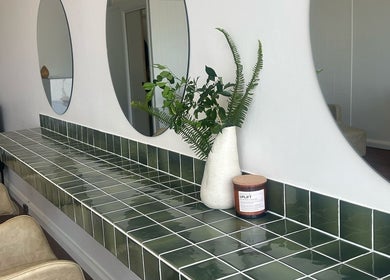 Elegant styling area at Jessi do my hair, Dee Why, New South Wales, AU, with green tiles and mirrors.