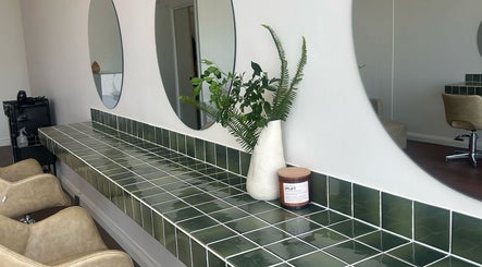 Elegant styling area at Jessi do my hair, Dee Why, New South Wales, AU, with green tiles and mirrors.