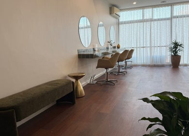 Modern salon interior at Jessi do my hair in Dee Why, New South Wales, AU with stylish chairs and mirrors.