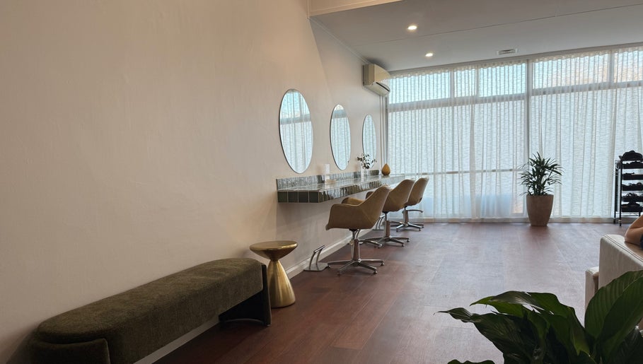Modern salon interior at Jessi Do My Hair, Dee Why, New South Wales. Features stylish chairs and round mirrors.