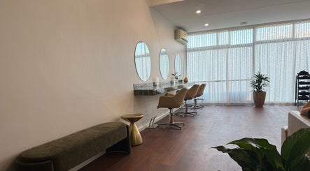 Modern salon interior at Jessi Do My Hair, Dee Why, New South Wales. Features stylish chairs and round mirrors.