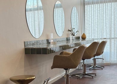 Modern salon interior at Jessi Do My Hair, Dee Why, New South Wales, AU with chic styling chairs and mirrors.