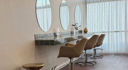 Modern salon interior at Jessi Do My Hair, Dee Why, New South Wales, AU with chic styling chairs and mirrors.