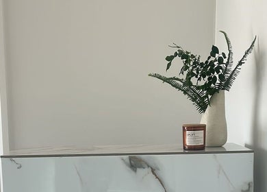 Elegant decor at Jessi Do My Hair, Dee Why, New South Wales, AU, showcasing a vase with greenery and a candle.