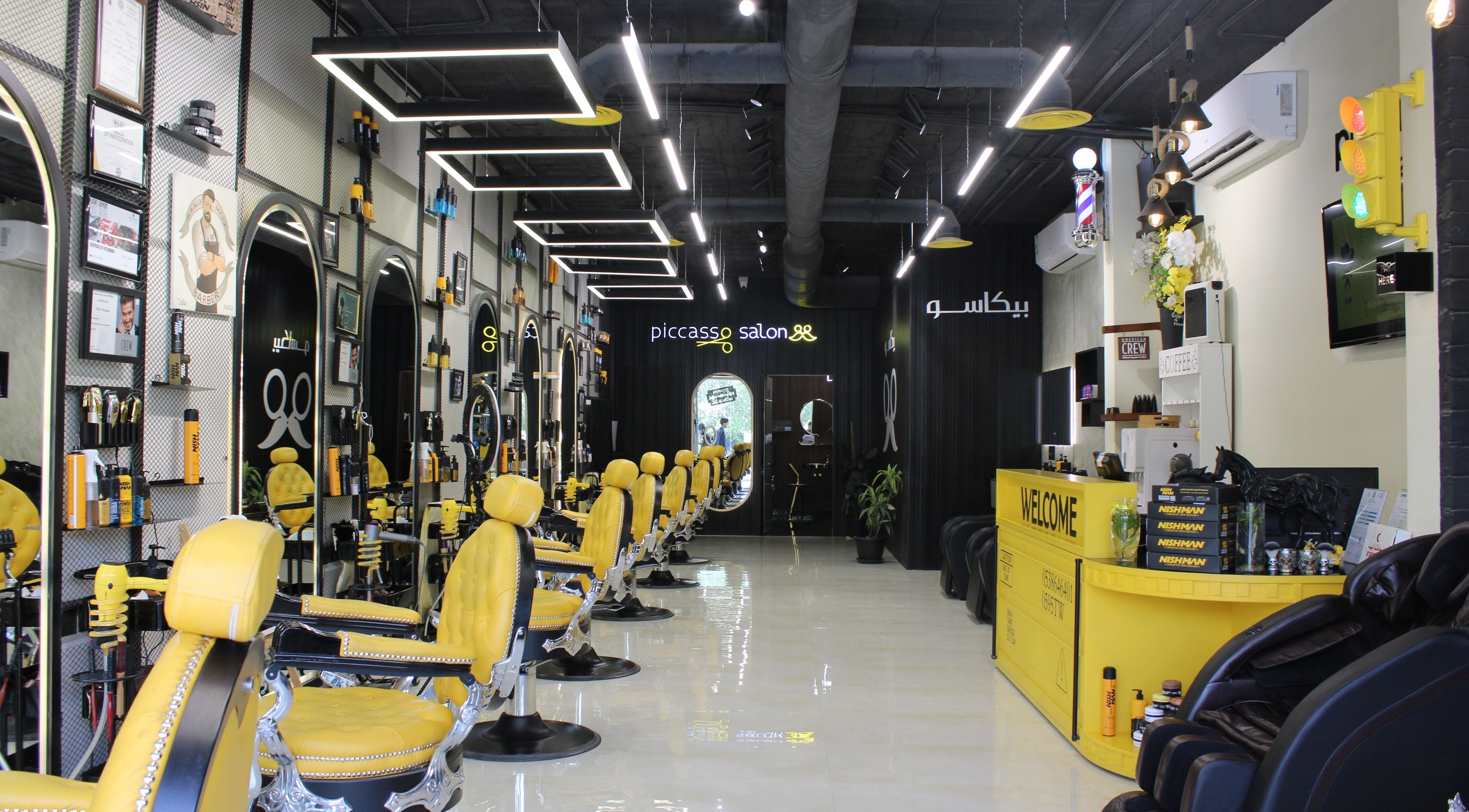 Interior of Picasso Barbershop in Riyadh featuring stylish yellow chairs and modern decor.