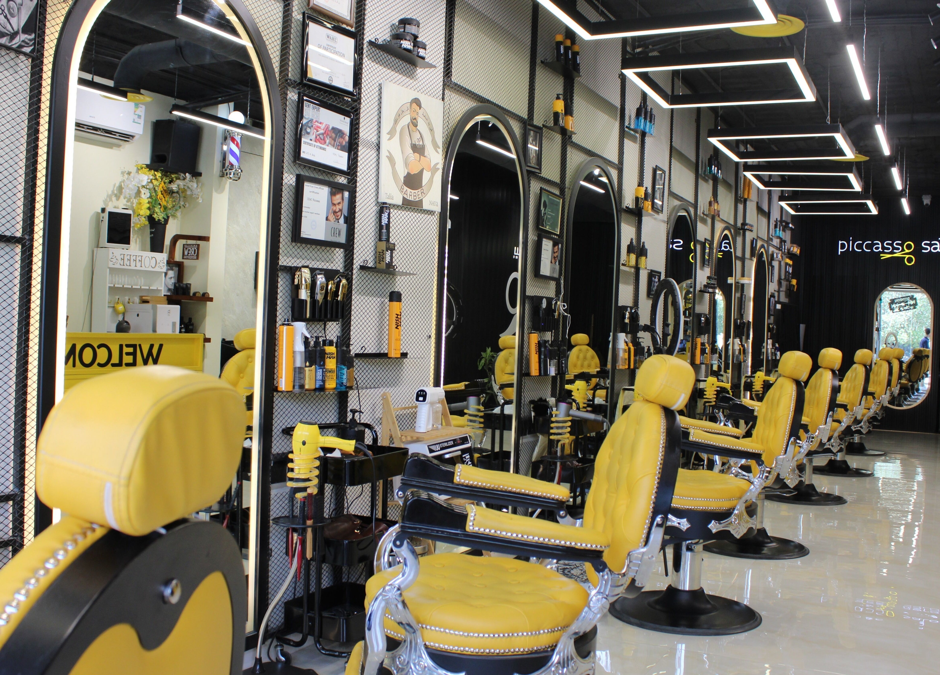 Elegant interior of Picasso Barbershop in Riyadh, Riyadh Province, SA with stylish yellow barber chairs.
