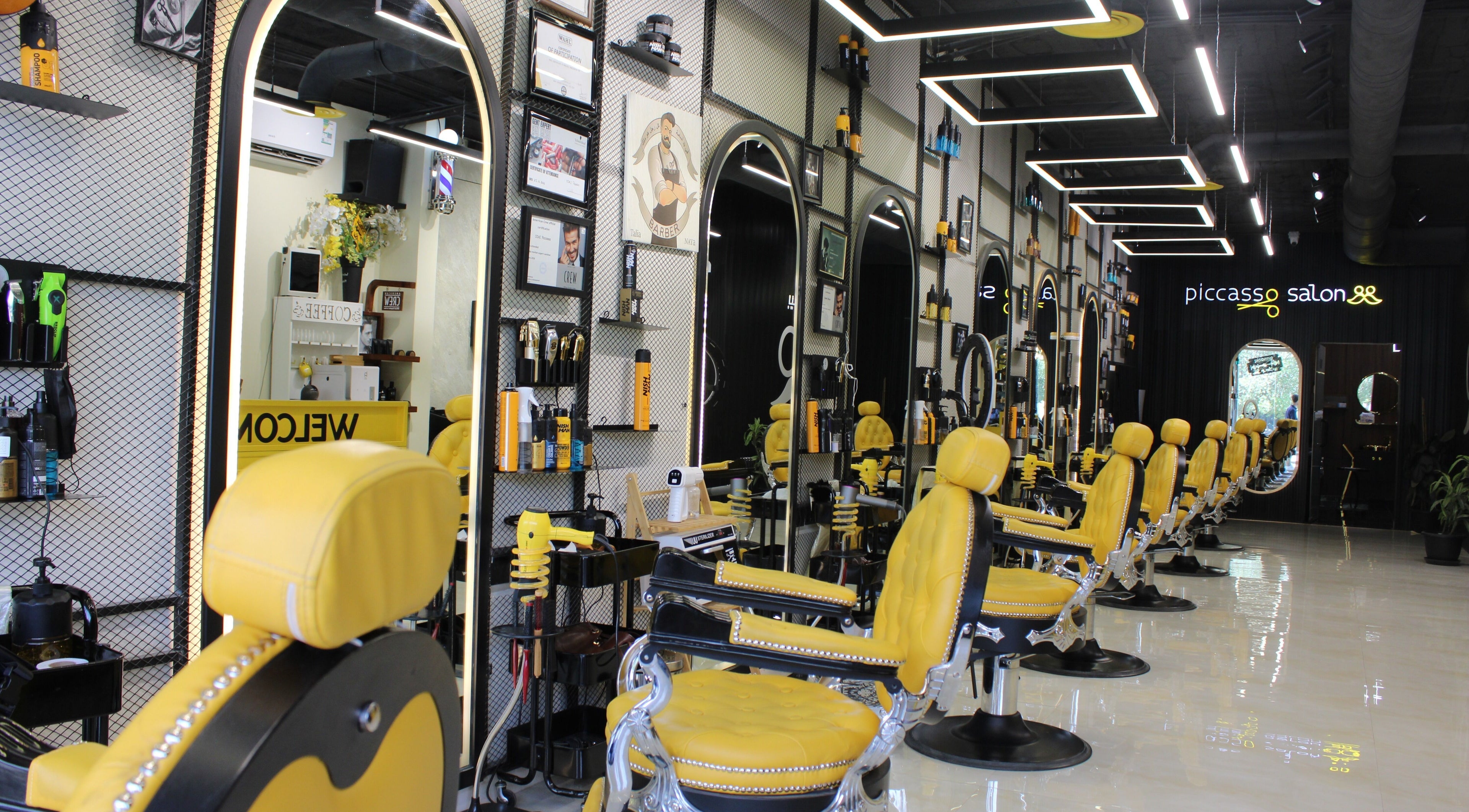 Elegant interior of Picasso Barbershop in Riyadh, Riyadh Province, SA with stylish yellow barber chairs.