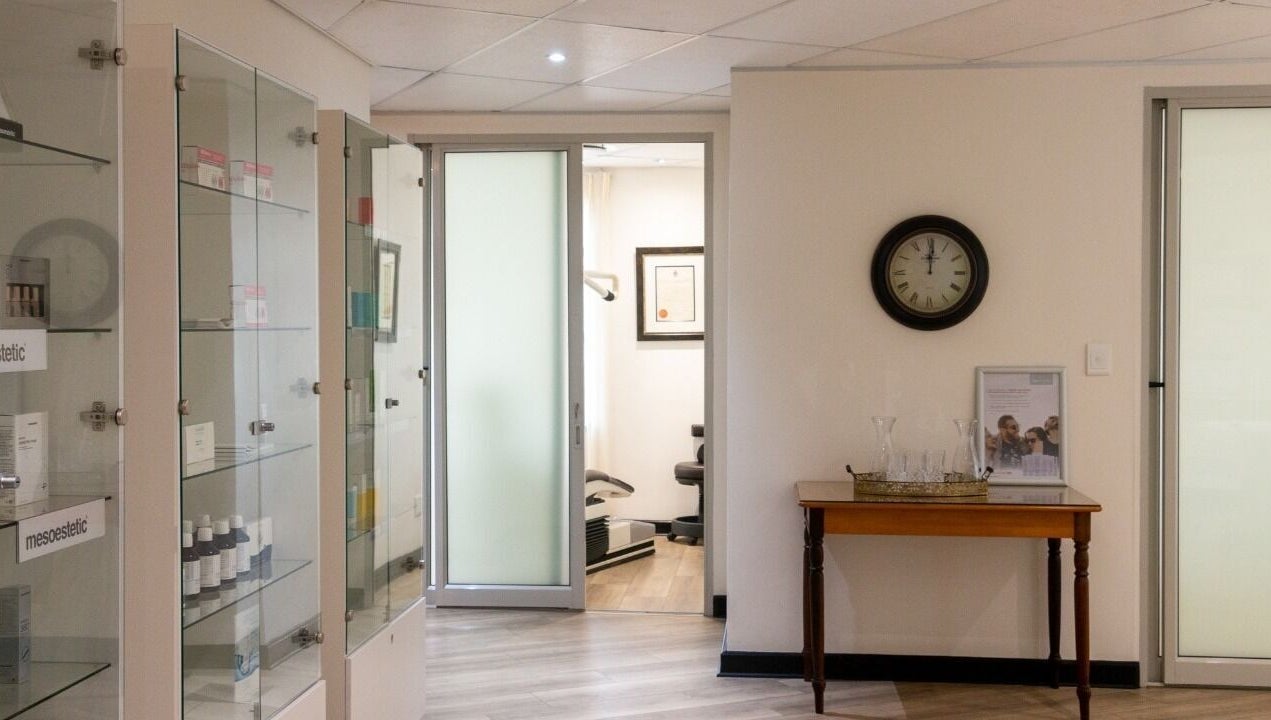 Elegant waiting area at Man Sense Waxing Studio in Johannesburg, Gauteng, ZA featuring glass cabinets and decor.