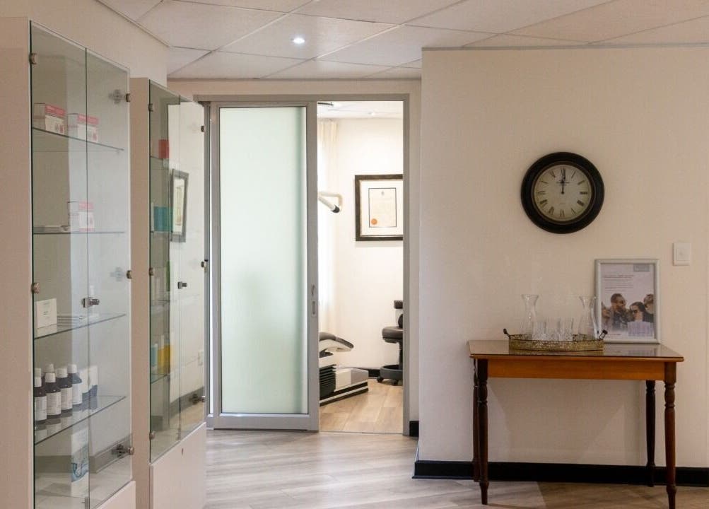 Elegant waiting area at Man Sense Waxing Studio in Johannesburg, Gauteng, ZA featuring glass cabinets and decor.