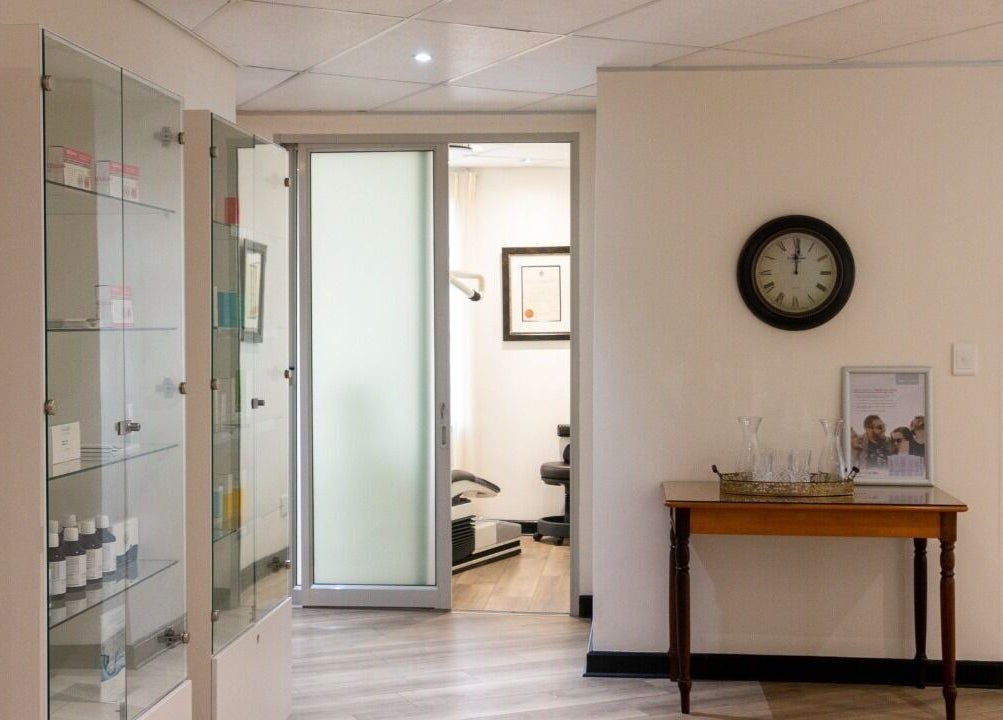 Elegant waiting area at Man Sense Waxing Studio in Johannesburg, Gauteng, ZA featuring glass cabinets and decor.