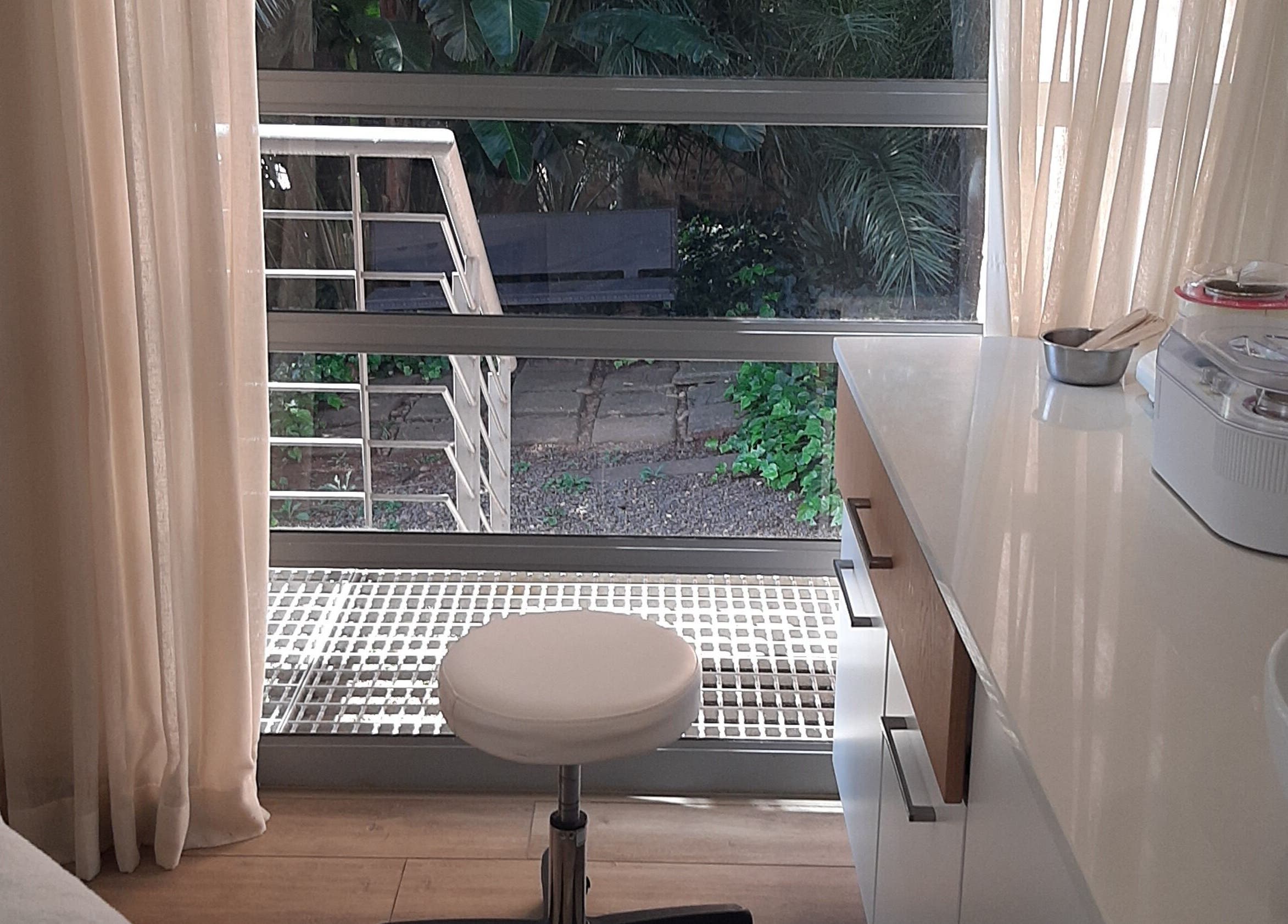 Bright and peaceful workspace at Man Sense Waxing Studio in Johannesburg, Gauteng, ZA with garden view.