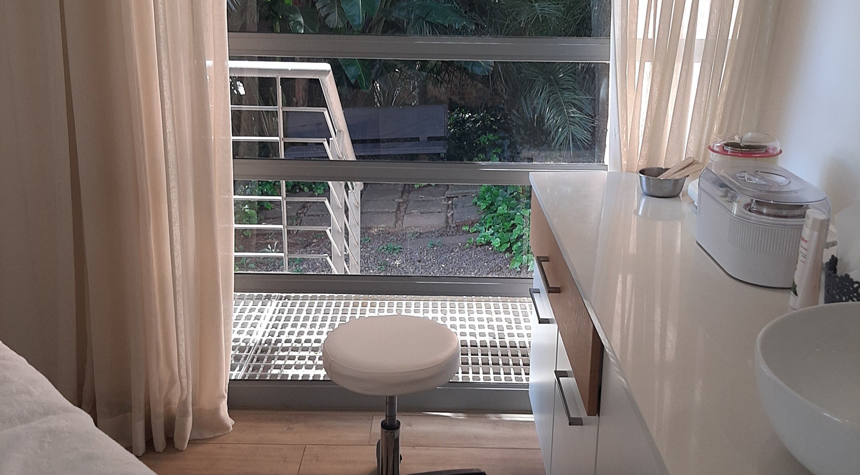 Bright and peaceful workspace at Man Sense Waxing Studio in Johannesburg, Gauteng, ZA with garden view.